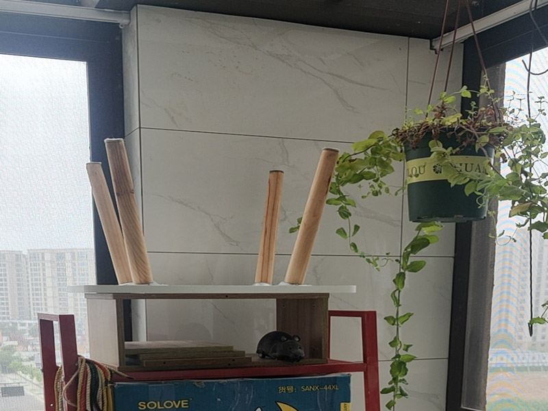 陽臺瓷磚鋪貼;準備粘結劑前，瓷磚不應浸水，但要用鋼絲刷除去磚背面的松散物質，并用濕布抹去磚背的浮塵。用符合所需膠層厚度的齒型抹刀的直邊將攪拌好的膠粘劑批到基面上，沿瓷磚縫方向將膠粘劑層梳理成均勻條狀。目的是為了控制粘結劑的厚度、用量并使瓷磚粘貼面積能夠更加均勻。在鋪壓瓷磚前，在瓷磚背面也批一薄層粘結劑。這種雙批法雖然用的材料和工時比較多，但卻能夠保證粘貼的質量和耐久性。在粘結劑量置晾時間內，將準備好的瓷磚鋪壓到位，垂直于梳理方向輕微搓動以排出磚下的空氣。鋪貼到位后用橡皮錘輕擊，用尺寸合適的十字定位架來調整表面平整度及接縫的平直。鋪設好的磚面應該及時清理干凈，特別是去除殘留其上的粘結劑。合格的粘結劑干硬后即使在陶瓷磚面上也不易被清除掉。清理好的瓷磚面應該立即擺放標識進行隔離，避免污染或擾動，直到下一個填縫工序。